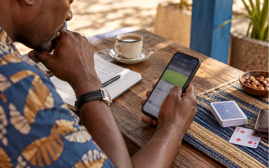 A phone, coupon and cards illustrate checking game and account information