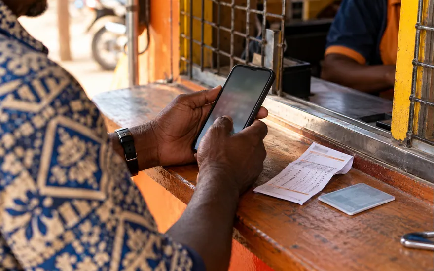 A customer checks account access beside an identity record at an agent counter