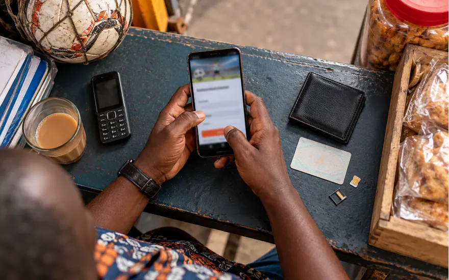 Hands review a phone, SIM and identification before opening an account